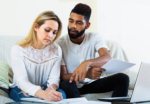 istock Couple filling papers for mortgage 531710690