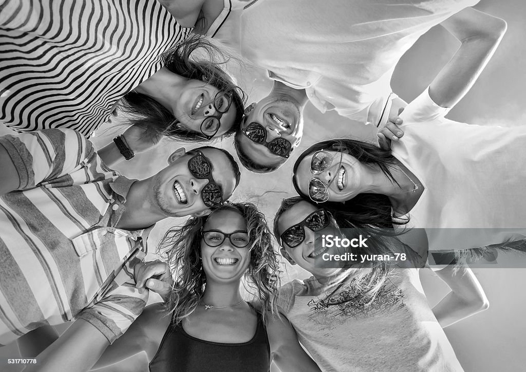 Group of friends on the beach under sunlight. Adult Stock Photo
