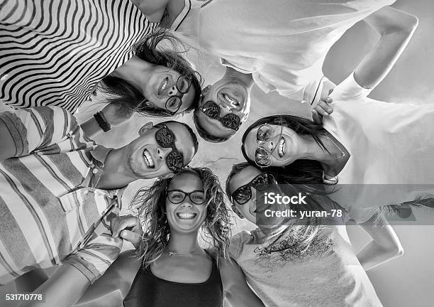 Group Of Friends On The Beach Under Sunlight Stock Photo - Download Image Now - Adult, Beach, Carefree