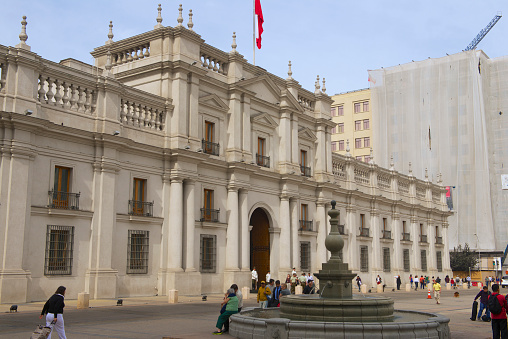 View from Plaza de la Constitucion, facade of Palacio de La Moneda in the government quarter of the metropolis Santiago de Chile, South America, April, 13th, 2023