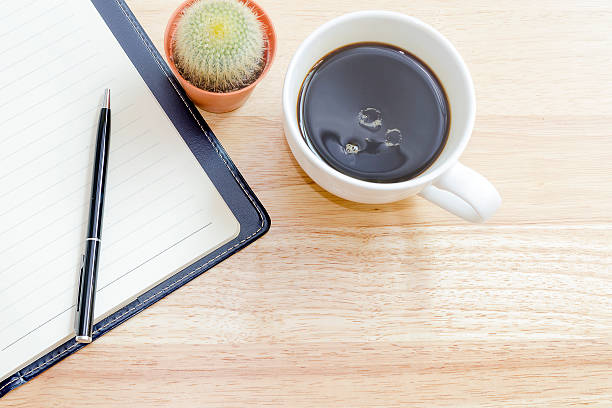 istock Office Table with notebook, pen, cup of coffee  and cactus 531712300