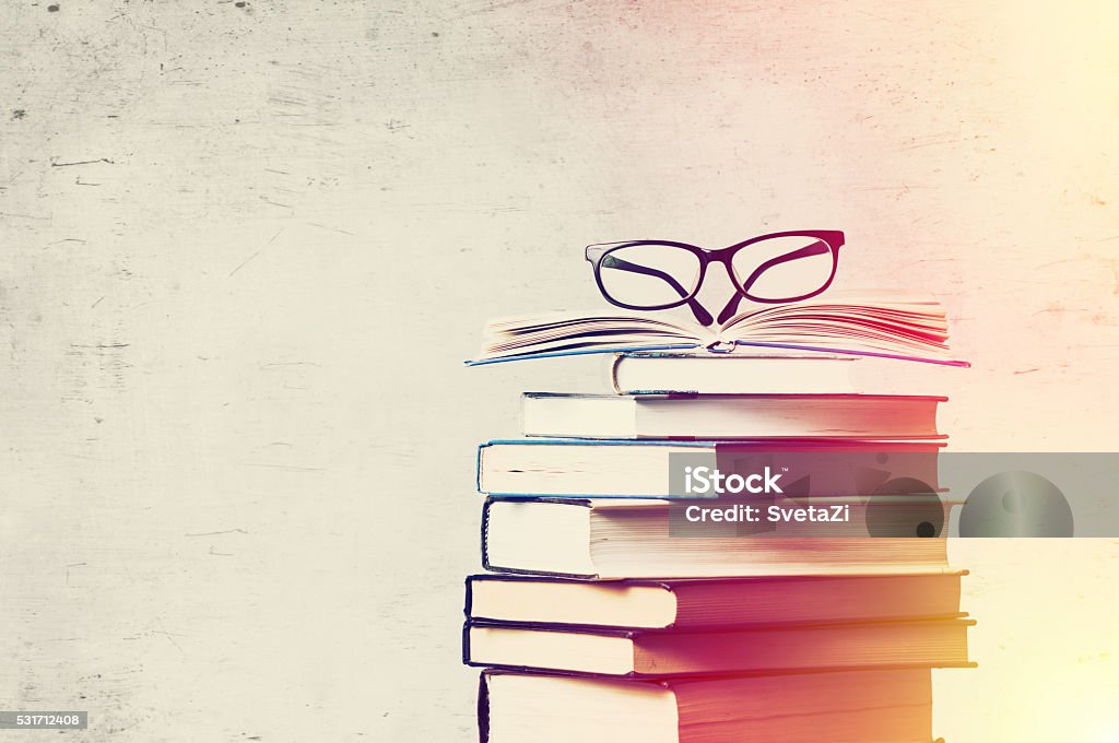 books and eyeglasses a pile of books and eyeglasses Post-Secondary Education Stock Photo