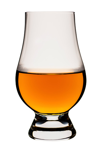 Glass of whisky isolated on white. Many people will envisage a whisky glass as a parallel sided tumbler with a thick base. Connoisseurs of whisky though, drink from the glass in the image. They instantly recognise its name, they use it for putting their nose in to judge the aroma, and never ever put ice in it, water in small drops yes, but never ice. Whisky vapour (known as Scotch mist) can be seen gathering on the inside of the glass just above the liquid surface. AdobeRGB colorspace.