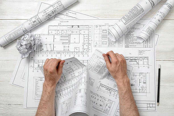 istock Close-up hands of architect tearing a bad drawing 531715174