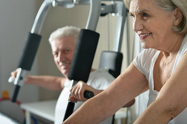 istock senior couple exercising in gym 531716372