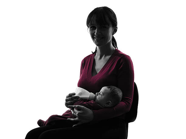istock woman feeding bottle baby  silhouette 531721293