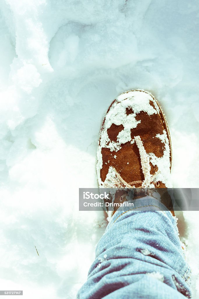 Suede Desert Boots and skinny jeans on a snowy field. Brown suede Desert Boots and skinny jeans on a snowy field. Shoe Stock Photo
