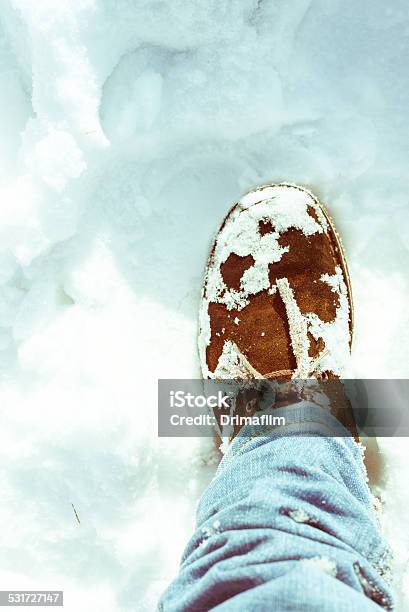 Suede Desert Boots And Skinny Jeans On A Snowy Field Stock Photo - Download Image Now