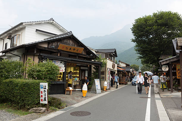 Yufu, Japan - September 2, 2014 : People walk past the Yufuin Shopping Street in Oita Prefecture, Japan. Yufuin is a popular hot spring resort in Japan. The shopping street is full of souvenir shops, cafes and boutiques. 