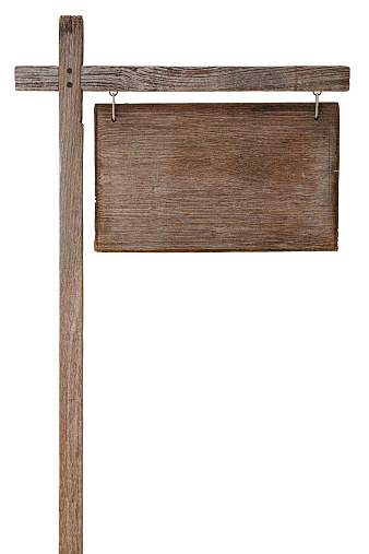 Old weathered wooden sign board hanging from a wooden post, isolated on white, clipping path included.