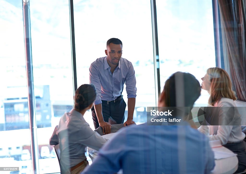 Do you know how big this deal is? Shot of group of colleagues having a meeting in the boardroom at the office 2015 Stock Photo