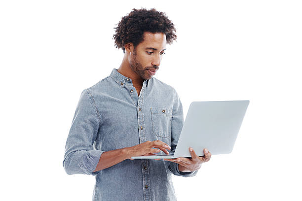 Spending time online Studio shot of a handsome man holding a laptop isolated on whitehttp://195.154.178.81/DATA/shoots/ic_783849.jpg men hairstyle afro cool stock pictures, royalty-free photos & images