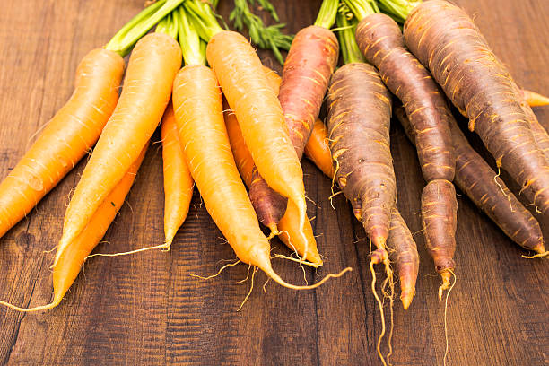 istock Old purple and current  orange sort of carrots 531737159