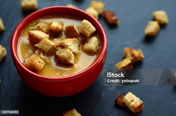 Pumpkin Soup With Homemade Croutons In A Small Red Bowl Stock Photo - Download Image Now