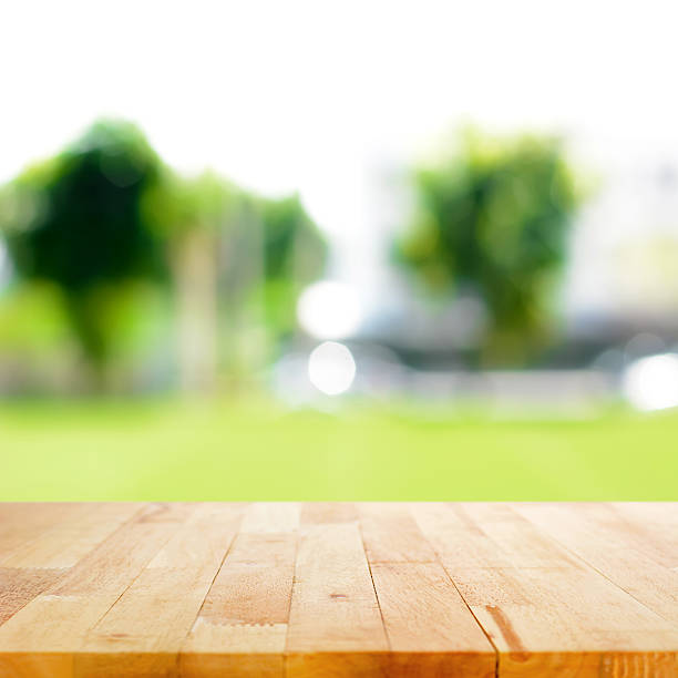 istock Wood table top on blurred green nature abstract background 531752787