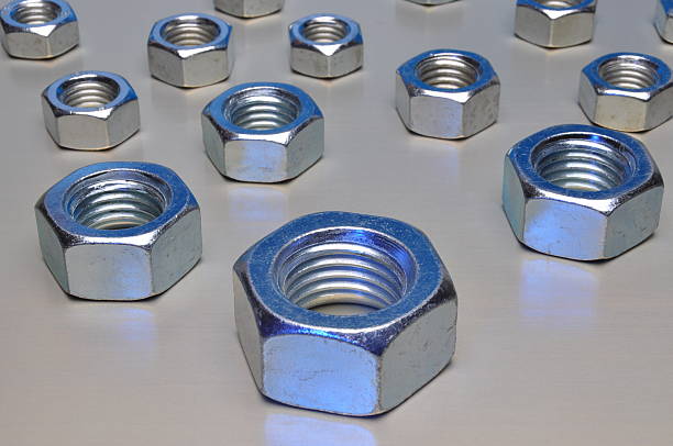 istock Group of steel nuts on metal surface 531755379
