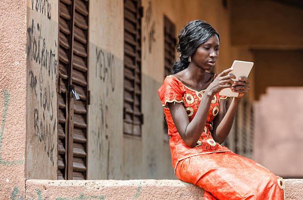 Reading Symbol: African Black Ethnicity Woman Reading On Tablet Computer stock photo