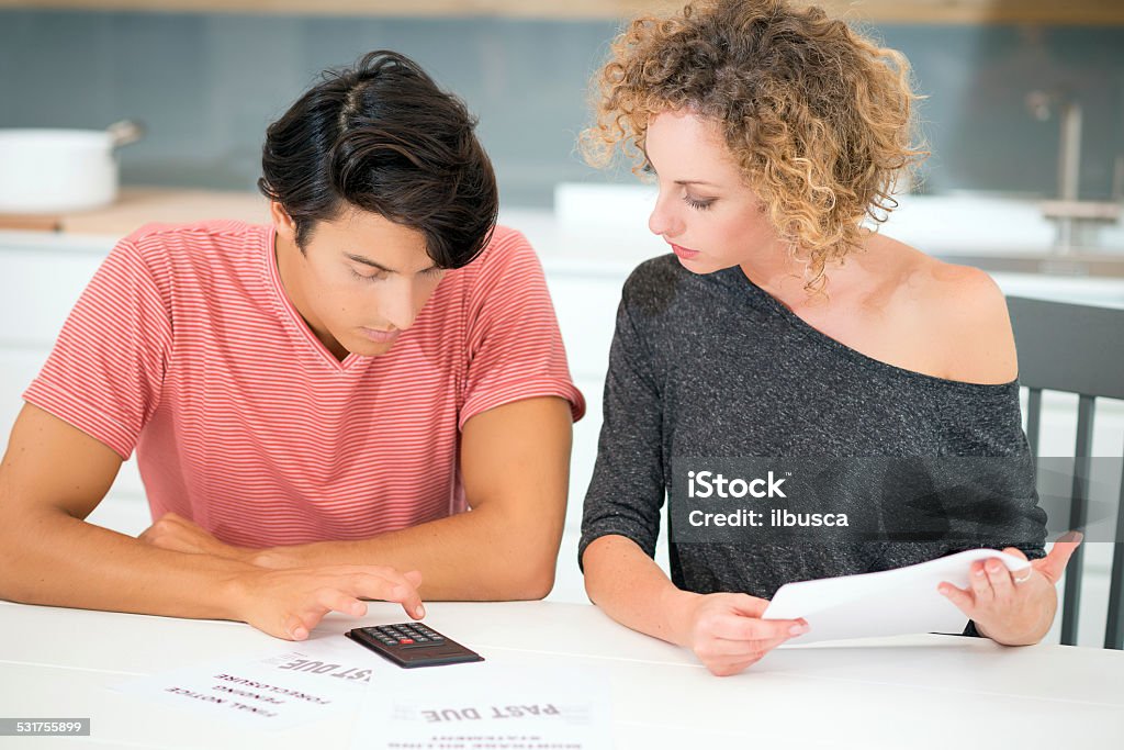 Couple with bills Couple with bills. 20-29 Years Stock Photo