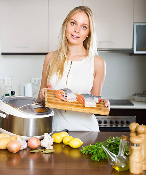 istock Woman cooking with multicooker 531756035