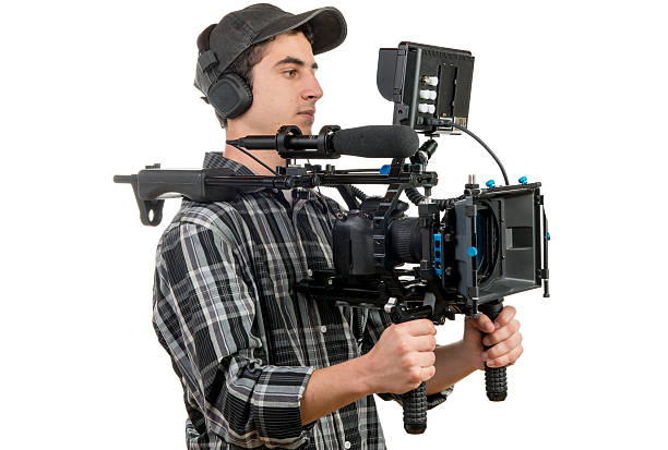 istock young cameraman with movie camera 531756619