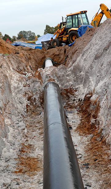 istock gas pipes and working excavator 531759359