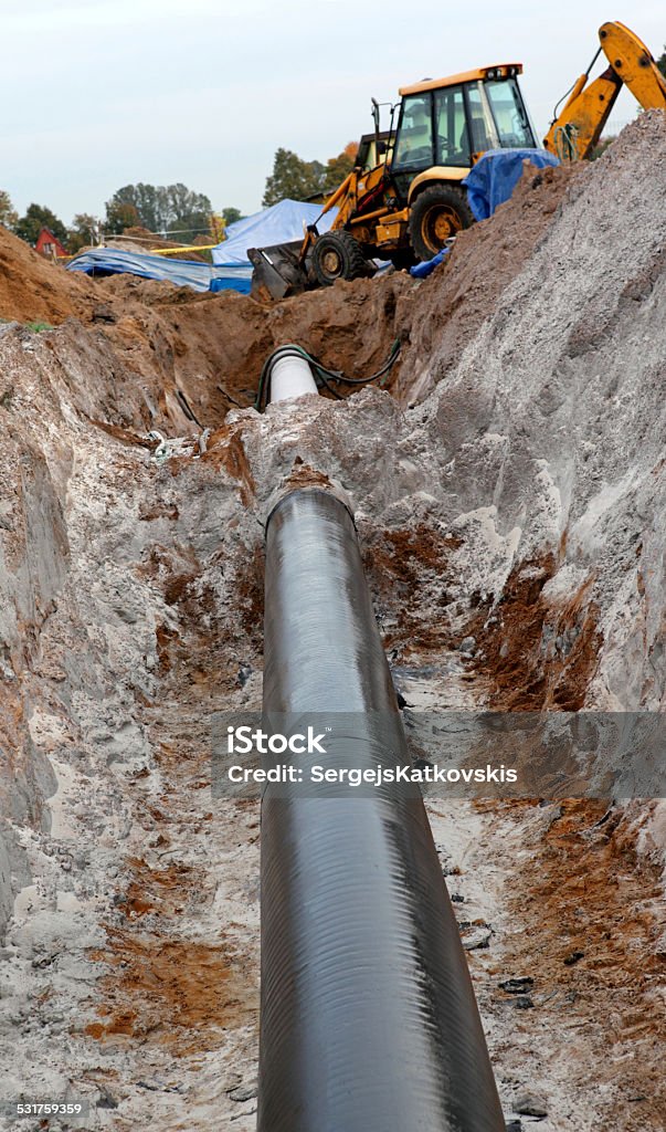 gas pipes and working excavator 2015 Stock Photo