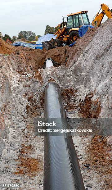 Gas Pipes And Working Excavator Stock Photo - Download Image Now - 2015, Agricultural Machinery, Backhoe