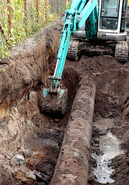 istock gas pipes and working excavator 531759381