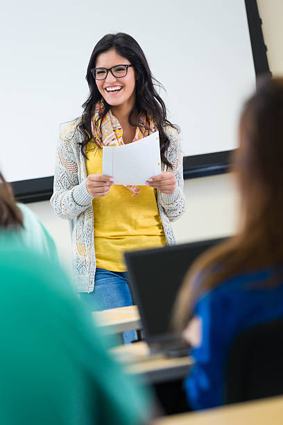 istock Intelligent student reading paper to college classmates 531770659