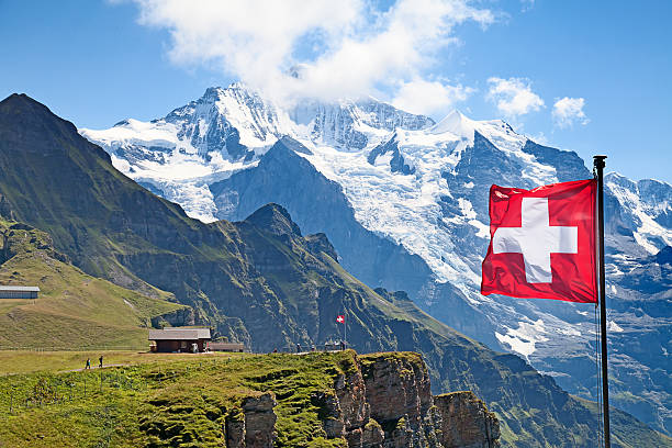 Swiss flag Swiss flag on the top of Mannlichen (Jungfrau region, Bern, Switzerland) jungfrau stock pictures, royalty-free photos & images