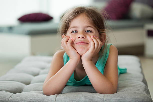 istock Happy little girl lying on Sofa 531771863