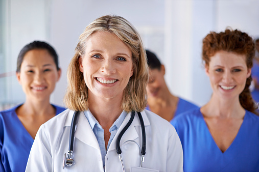 Portrait of a mature female doctor with a group of nurses standing behind herhttp://195.154.178.81/DATA/istock_collage/0/shoots/785087.jpg