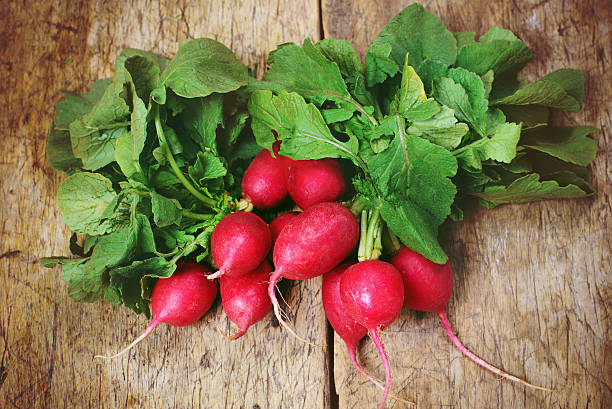 istock Fresh radishes on old wooden table 531773714