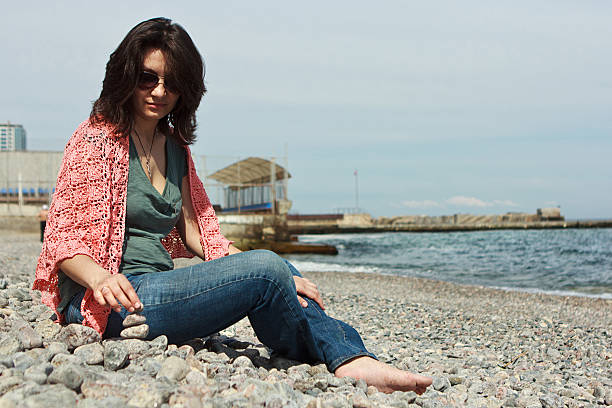 istock Young woman resting on sea beach 531774241