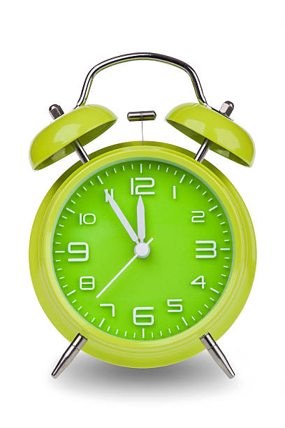 istock Green alarm clock with hands at 5 minutes till 12 531774807