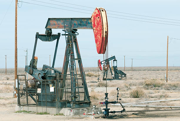istock Pump jacks and almond orchard in central California 531774901