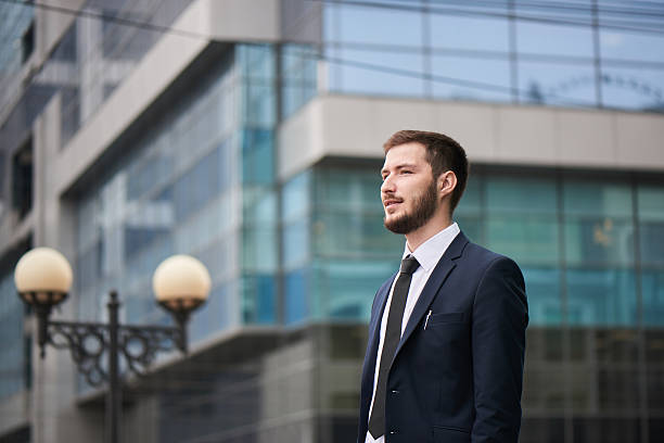 istock Businessman standing on background of office building 531775192
