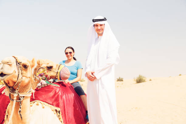 istock arabian man and tourist riding a camel 531775275