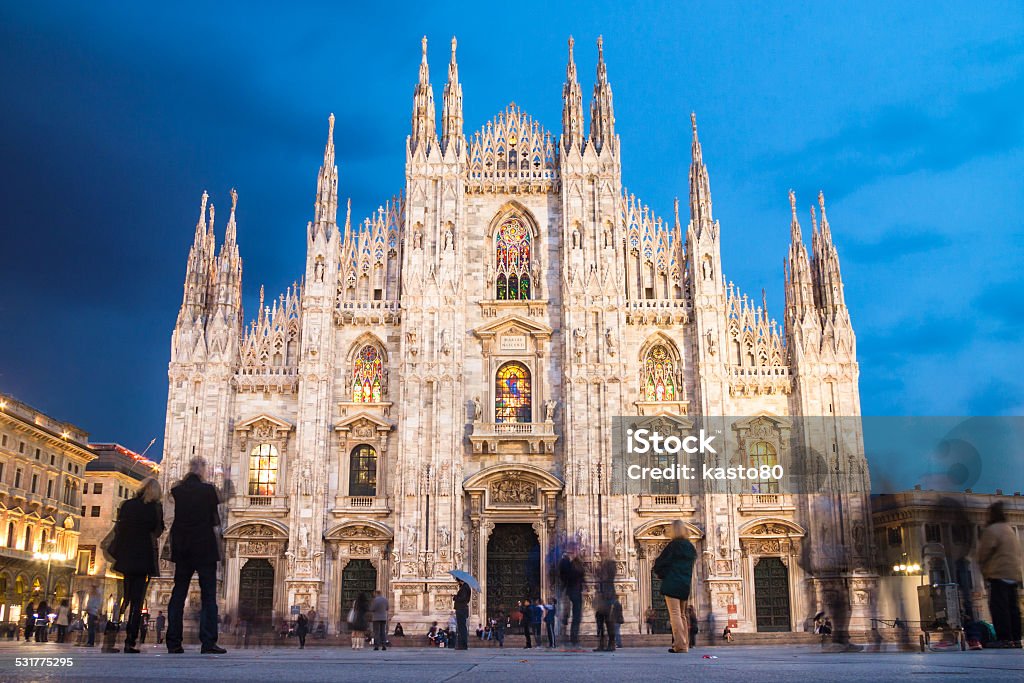 Milan Cathedral from the Square Milan Cathedral - Duomo di Milano - is the gothic cathedral church of Milan, Italy. Shot in the dusk from the square ful of people. 2015 Stock Photo