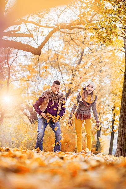 istock Couple throwing leaves in the air. 531775775