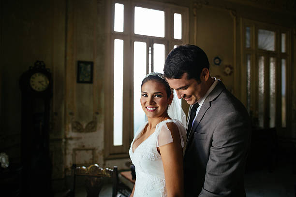 istock Bride and groom standing together in old house 531776326
