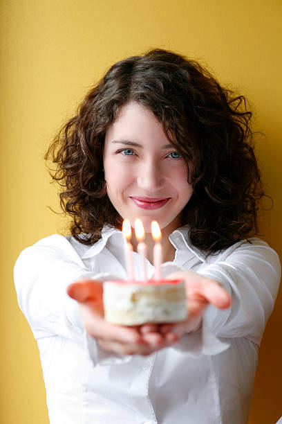 istock Young woman offering birthday cake. 531776934