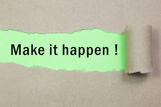 istock Make it happen! appearing behind torn brown paper. 531778754