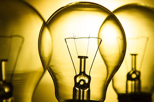 istock Row of light bulbs on a bright yellow background 531780762