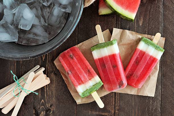istock Homemade watermelon popsicles with ice bucket on rustic wood 531781134
