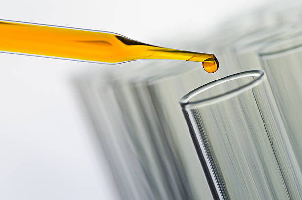 istock science laboratory pipette with drop on test tube background , l 531782308
