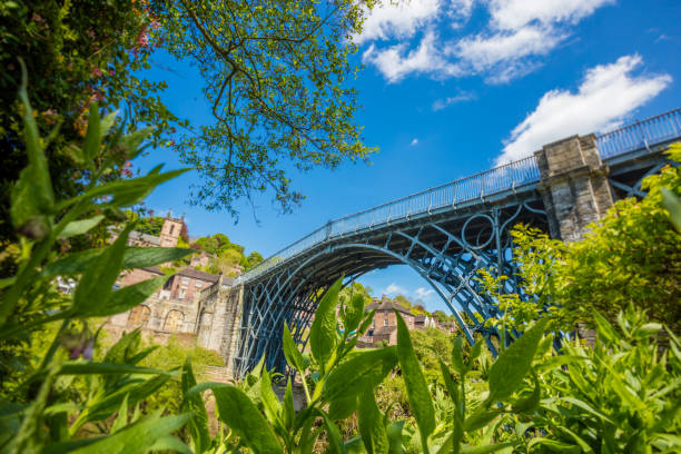 Ironbridge A stock photo of Iron bridge in Shropshire, England. It lies in the civil parish of The Gorge, in the borough of Telford and Wrekin. The famous Iron Bridge is a 100 ft cast iron bridge that was built across the river in 1779. Photographed with the Canon EOS 5DSR. ironbridge shropshire stock pictures, royalty-free photos & images