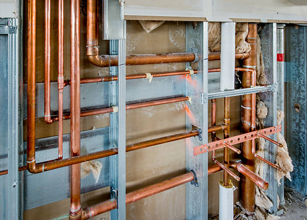 soldering of copper water pipes. Soldering of water distribution pipelines in the apartment. Copper plumbing pipe. Home repair, remodeling concept. High quality photo