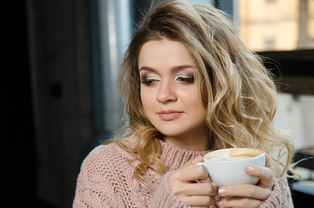 istock Coffee. Beautiful Girl Drinking Coffee in Cafe. Beauty Model 531784398