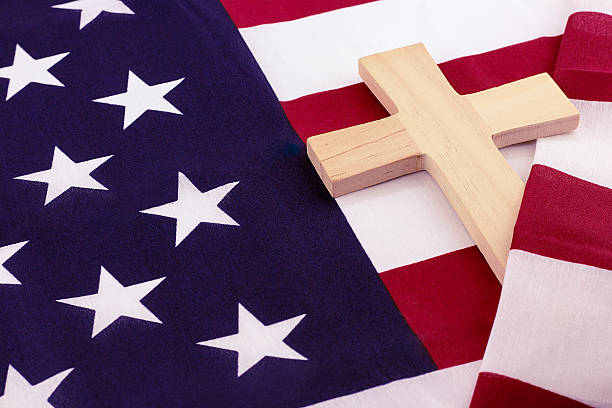istock Wooden cross wrapped in American flag 531784964